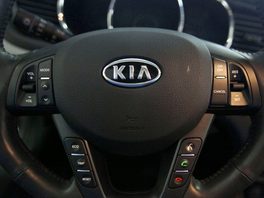 The Kia logo brands a steering wheel inside of a Kia car dealership in Elmhurst, Ill., Oct. 5, 2012.