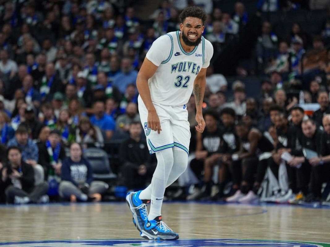 Minnesota Timberwolves center Karl-Anthony Towns (32) grimaces after an injury during the second half of the team's NBA basketball game against the Brooklyn Nets, Saturday, Feb. 24, 2024, in Minneapolis.