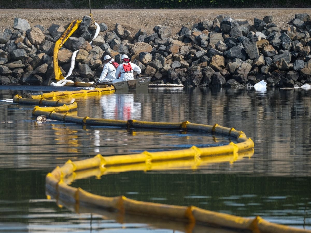 California Oil Spill Cleanup crew deploying "skimmers" and floating boom barriers to stop further incursion into the Wetlands Talbert Marsh in Huntington beach.