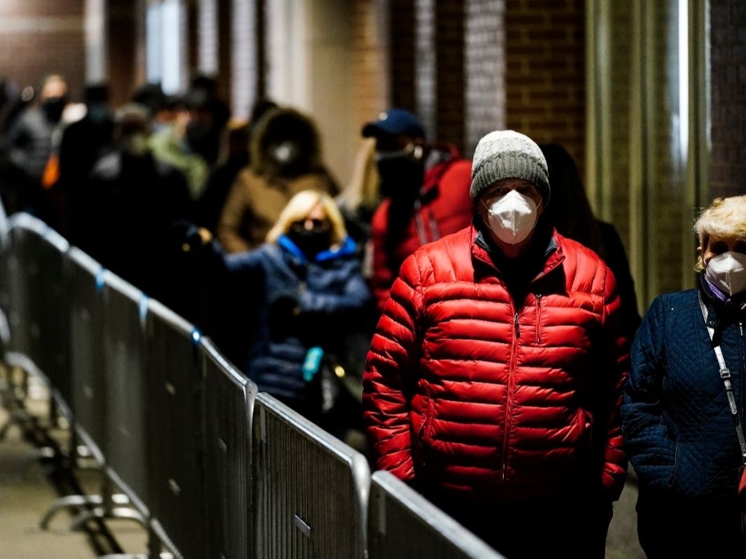 People wait in line at a FEMA Community Vaccination Center at the Pennsylvania Convention Center in Philadelphia, Wednesday, March 3, 2021.