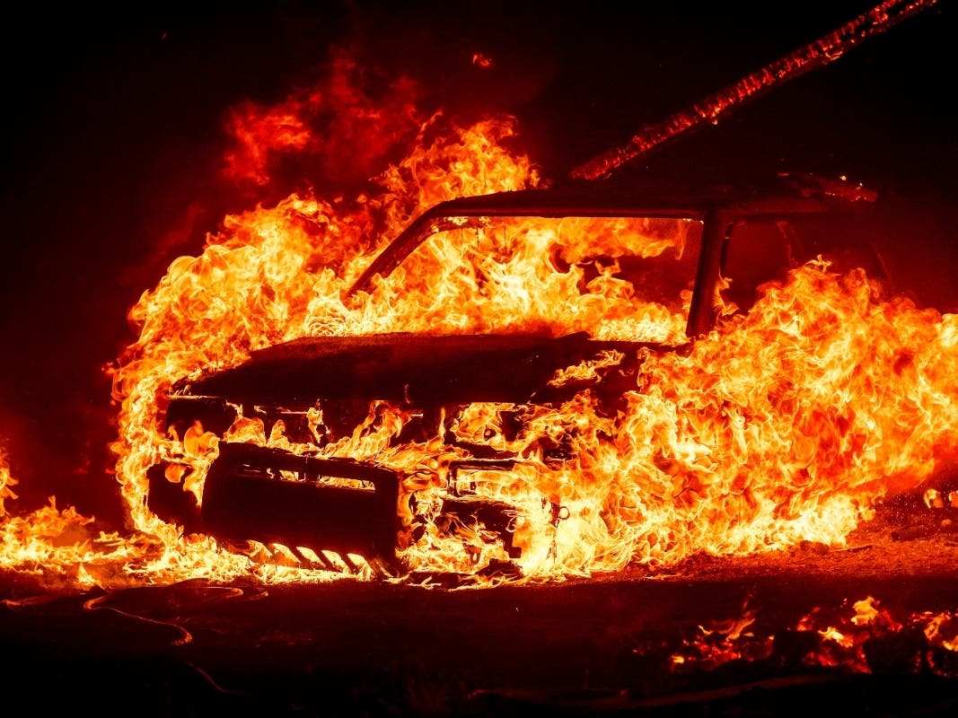 Flames consume a vehicle as the Park Fire jburns in Tehama County, Calif., on Friday, July 26, 2024. 