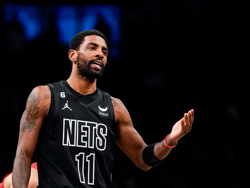 Brooklyn Nets guard Kyrie Irving (11) gestures during the first half of the team's NBA basketball game against the Toronto Raptors on Friday, Dec. 2, 2022, in New York. 