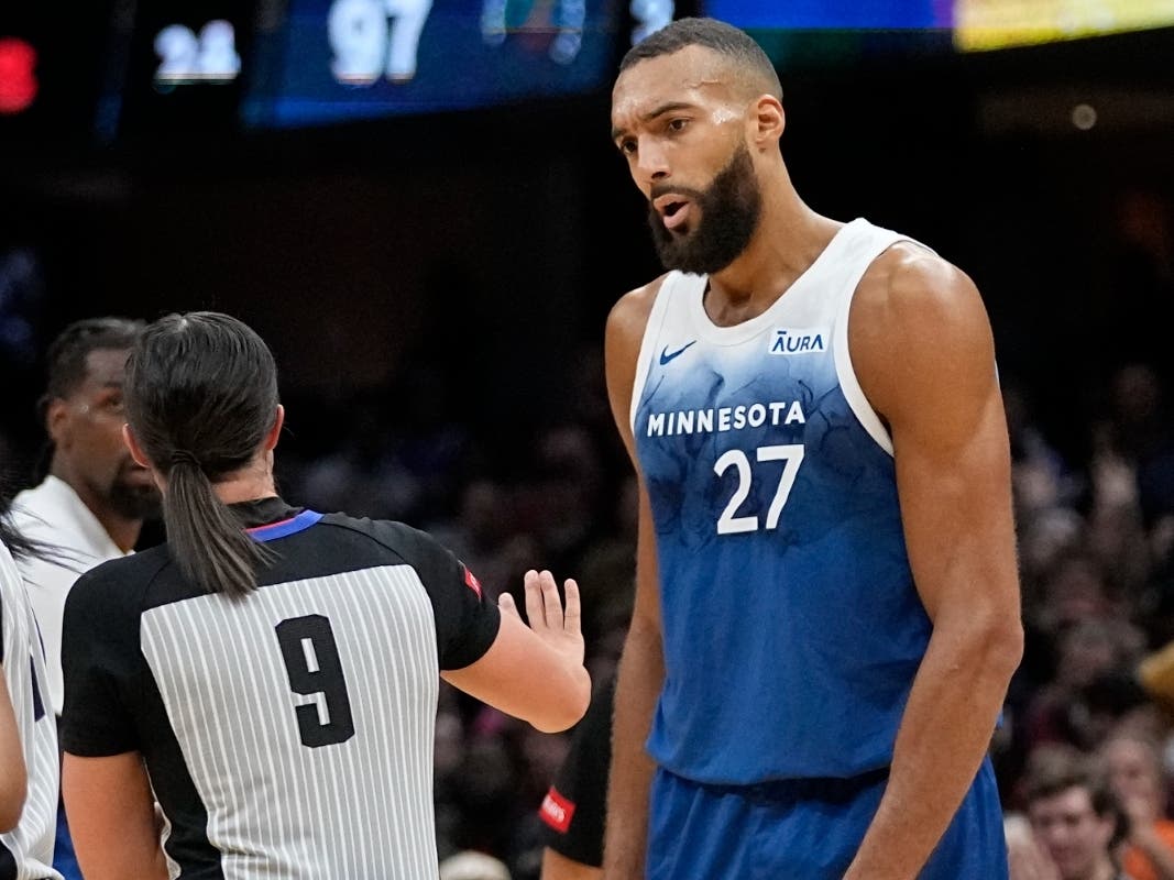 Minnesota Timberwolves center Rudy Gobert (27) talks with referee Natalie Sago (9) after being called for a technical foul in the second half of an NBA basketball game against the Cleveland Cavaliers, Friday, March 8, 2024, in Cleveland.