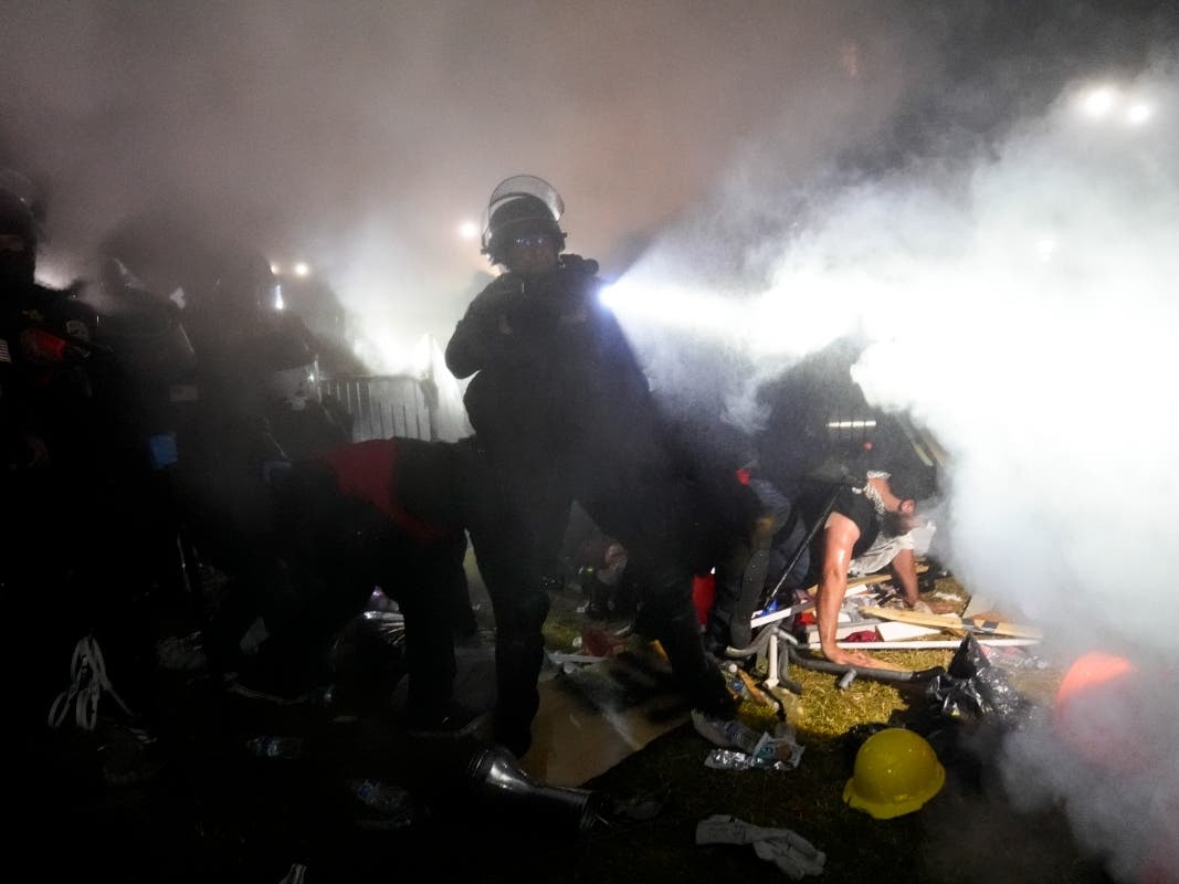 Police enter an encampment set up by pro-Palestinian demonstrators on the UCLA campus Thursday, May 2, 2024, in Los Angeles.