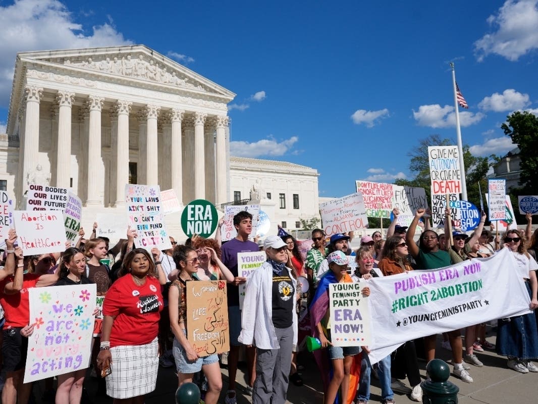 Abortion rights activists and Women's March leaders protest as part of a national day of strike actions outside the Supreme Court on Monday in Washington.