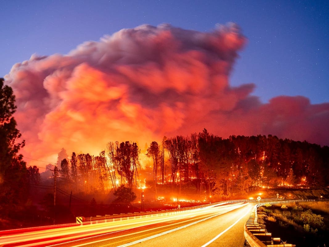 Seen in a long exposure photograph, the Park Fire burns along Highway 32 in the Forest Ranch community of Butte County, Calif., on Thursday, July 25, 2024.