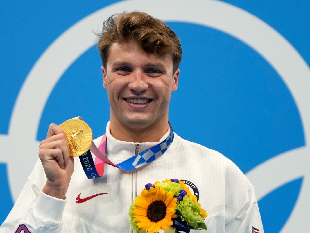 Bobby Finke of the United States poses with his gold medal for the men's 800-meters freestyle final at the Summer Olympics in Tokyo.