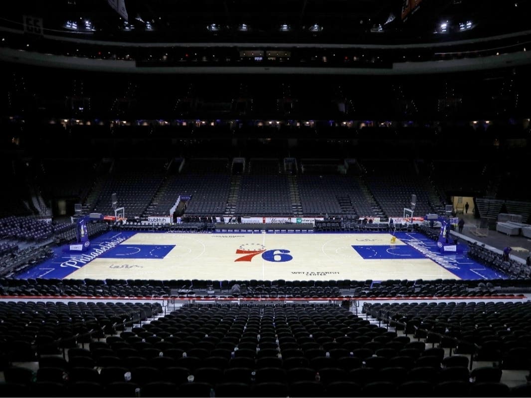 FILE - The empty court at the Wells Fargo Center is shown March 11, 2020, after an NBA basketball game between the Philadelphia 76ers and the Detroit Pistons, in Philadelphia.