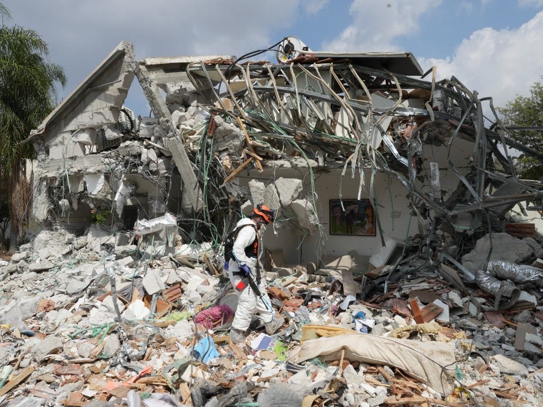 An Israeli soldier walks by a house destroyed by Hamas militants in Kibbutz Be'eri on Wednesday, Oct. 11, 2023. The kibbutz was overrun by Hamas militants from Neraby Gaza Strip Saturday when they killed and captured many Israelis.