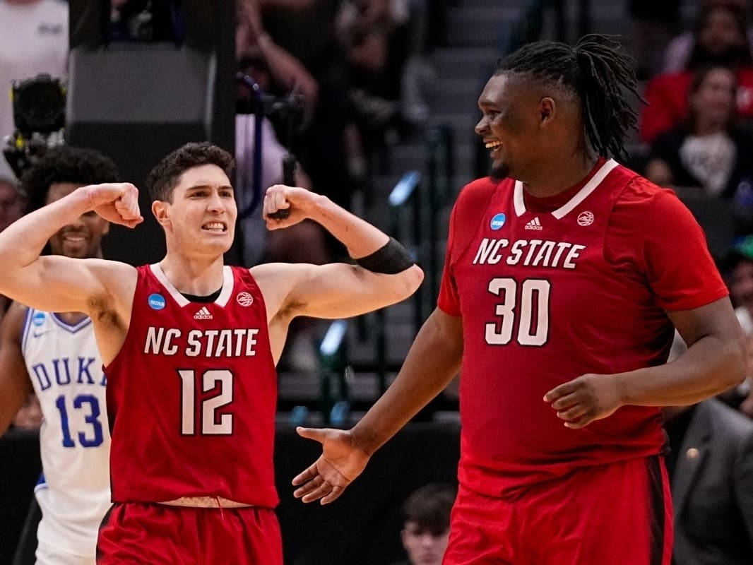 North Carolina State's Michael O'Connell (12) reacts after a basket by DJ Burns Jr. (30) against Duke during the second half of an Elite Eight college basketball game in the NCAA Tournament in Dallas, Sunday, March 31, 2024.