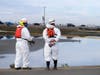 Cleanup contractors get ready to work in the Wetlands Talbert Marsh after an oil spill in Huntington Beach, Calif., on Monday, Oct. 4, 2021. 