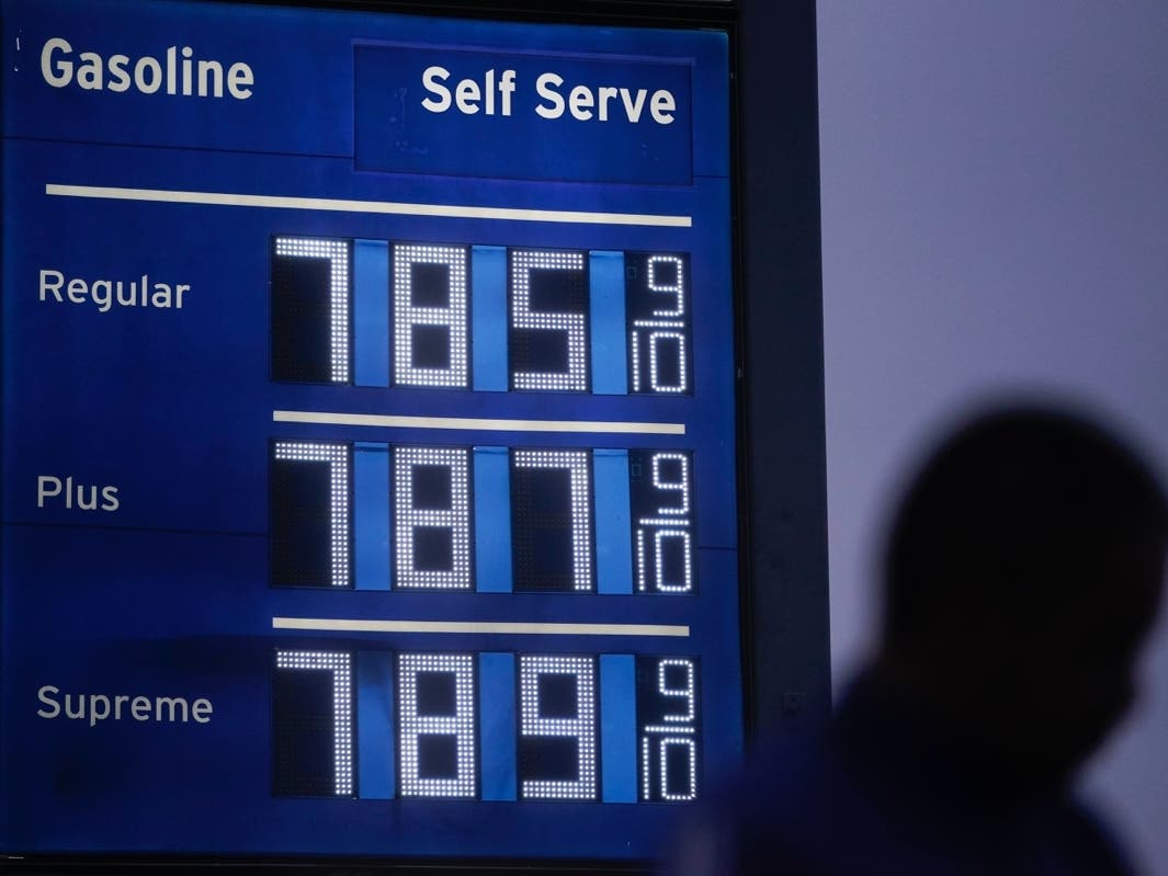 High gas prices are shown as a pedestrian waits to cross the street in Los Angeles, June 16, 2022. 