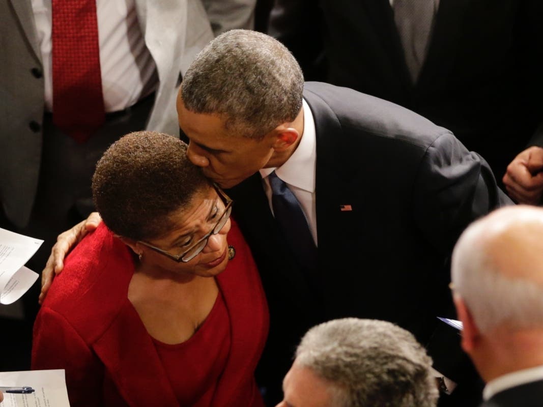 President Barack Obama kissed Rep. Karen Bass, D-Calif., on Capitol Hill in Washington, Tuesday, Jan. 20, 2015, after he gave his State of the Union address before a joint session of Congress. 