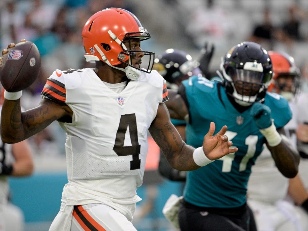 Cleveland Browns quarterback Deshaun Watson (4) looks for a receiver as he is pressured by Jacksonville Jaguars linebacker Josh Allen (41) during the first half of an NFL preseason football game, Friday, Aug. 12, 2022, in Jacksonville, Fla.