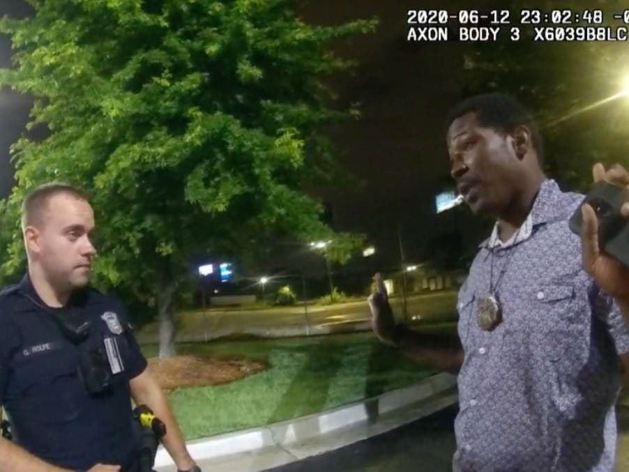 This screen grab taken from body camera video provided by the Atlanta Police Department shows Rayshard Brooks, right, as he speaks with Officer Garrett Rolfe, left, in the parking lot of a Wendy's restaurant in Atlanta, June 12, 2020.