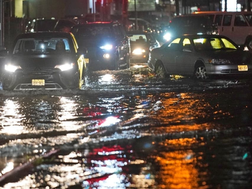 Cars make their way through flooded streets and abandoned cars in Bergen County last night. 