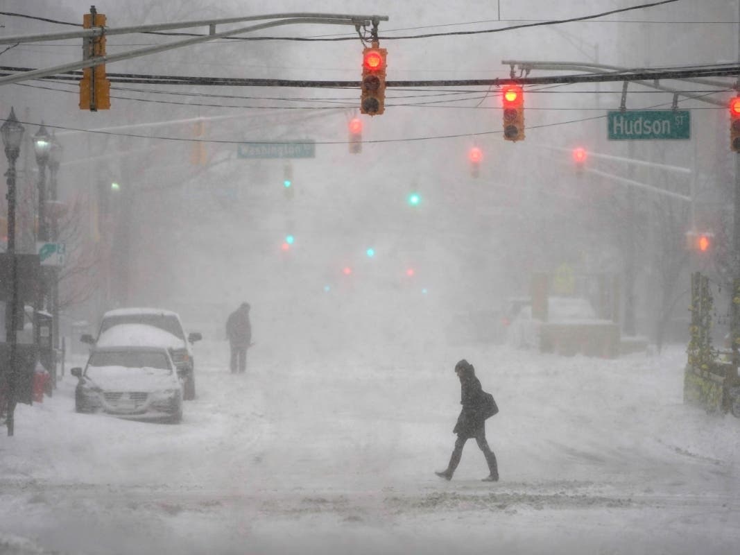 Pedestrians make their way through heavy snow and wind in Hoboken, N.J., Monday, Feb. 1, 2021.