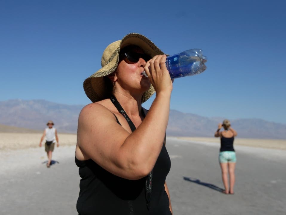 Maria Wieser, of Italy, takes a drink of water while sightseeing in Death Vally National Park, CA during a previous heat wave. Excessive heat warnings will continue for much of the Southwest all week.