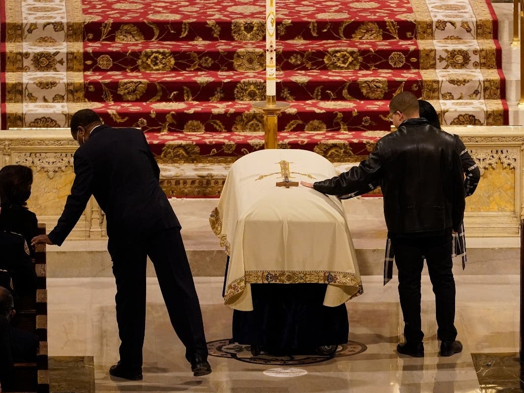 Family members touch the casket of New York Police Department Officer Jason Rivera during a funeral service Friday at St. Patrick's Cathedral in New York City. 