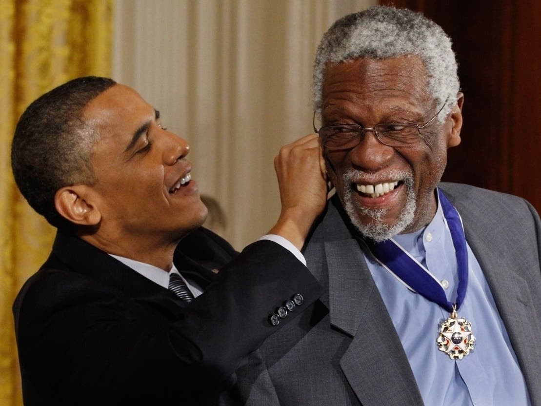 U.S. President Barack Obama (L) presents Basketball Hall of Fame member and human rights advocate Bill Russell the 2010 Medal of Freedom in the East Room of the White House February 15, 2011 in Washington, DC.
