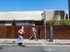 A man jogs while wearing a face mask near shuttered Venice Beach amid the coronavirus pandemic on March 28, 2020 in Venice, California.