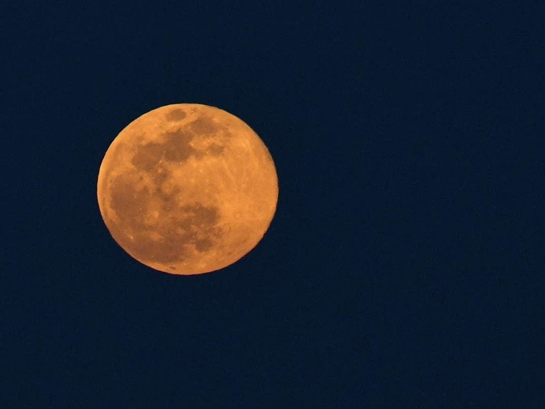 The super pink moon rises Monday over Glenview. The pink moon got its name because the April full moon occurs at the same time the pink wildflower phlox blooms in North America. 