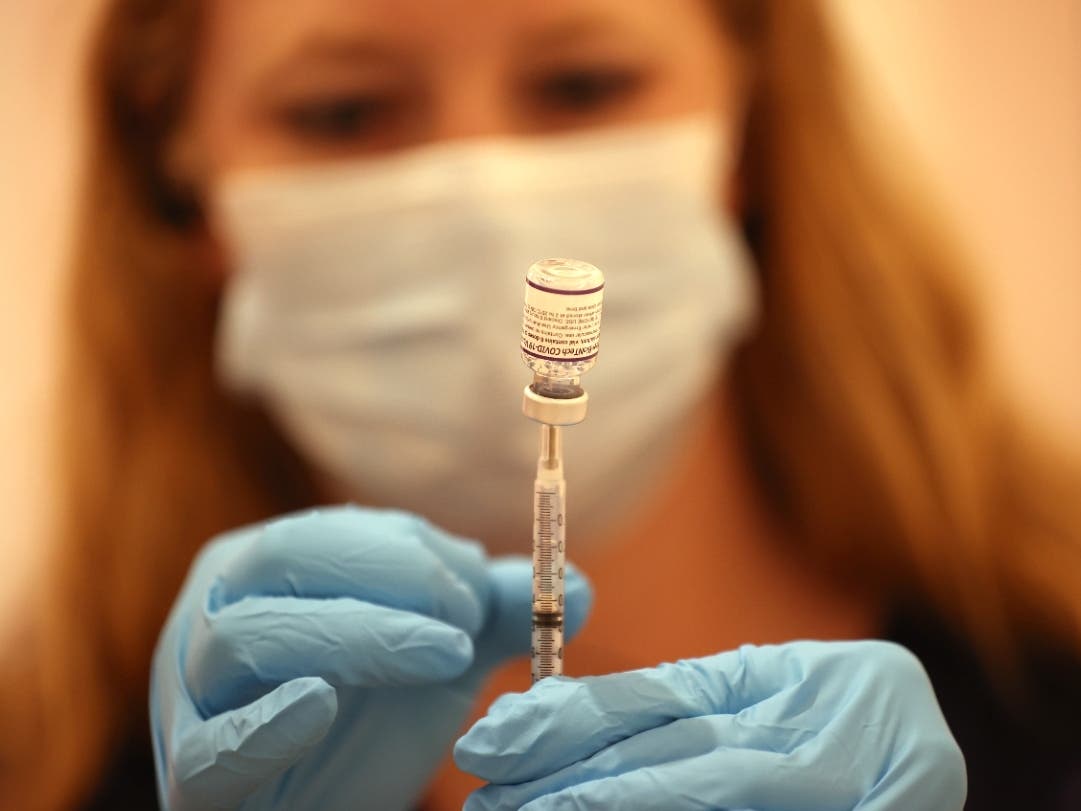 Safeway pharmacist Ashley McGee fills a syringe with the Pfizer COVID-19 booster vaccination at a clinic in San Rafael in October.