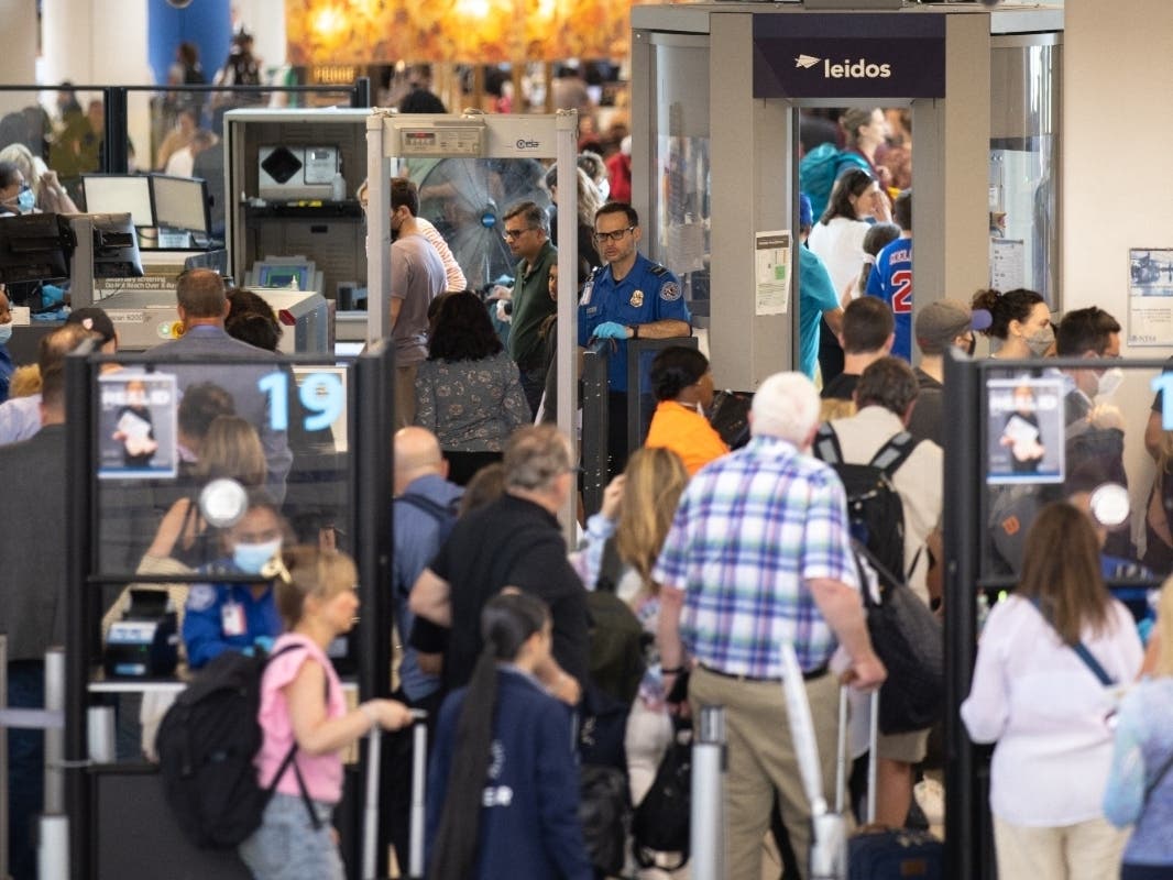 Travelers line up to enter a security checkpoint at Newark (New Jersey) Liberty International Airport on July 1 at the beginning of the Independence Day travel weekend, when hundreds of flights were cancelled across the United States.