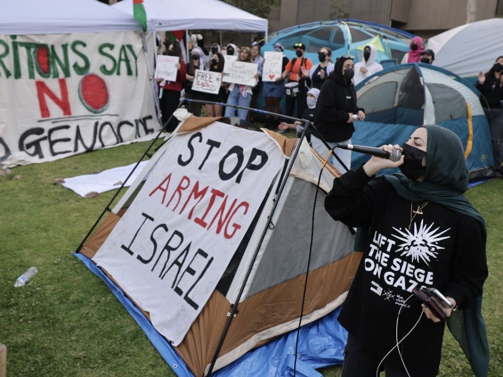 A pro-Palestinian protester uses a microphone to lead chants as students and supporters protest the war in Gaza at an encampment they set up at UC San Diego in San Diego on Wednesday, May 01, 2024.