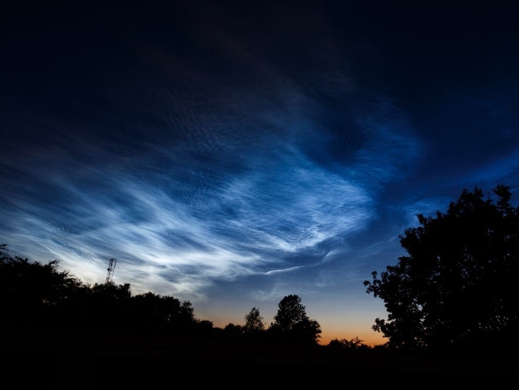 Noctilucent “electric blue” clouds float about 50 miles above Earth, touching the edge of space.  They've visible through the first of August, but especially near the June 21 summer solstice, when the sun illuminates them long after it has set on Earth.