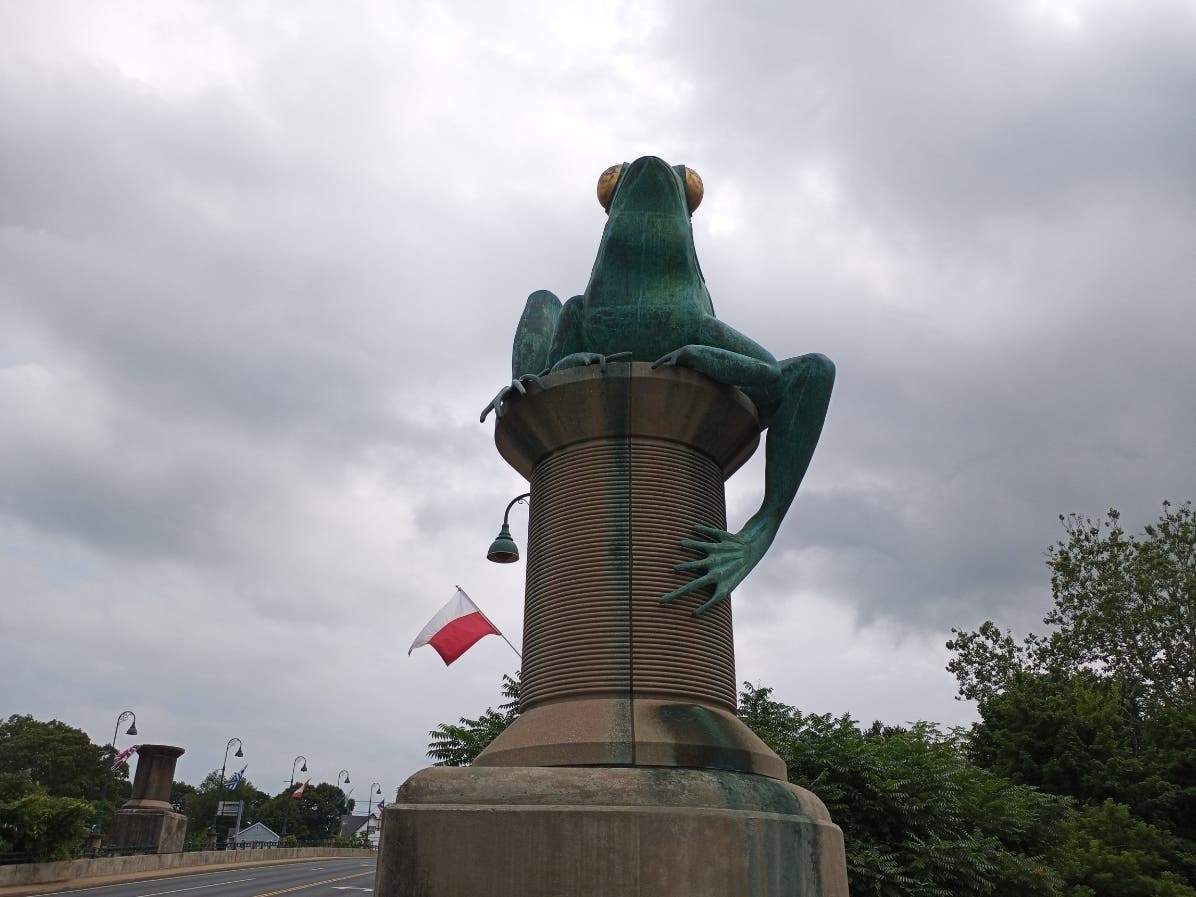 A frog — one of four — sits as a sentinel at a now-famous bridge in Willimantic. 