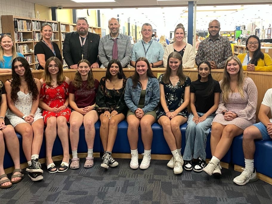 Rockville High School's Top 10 Scholars, seated, and the teachers they honored, who are standing behind them, celebrated the annual lunch this week. 