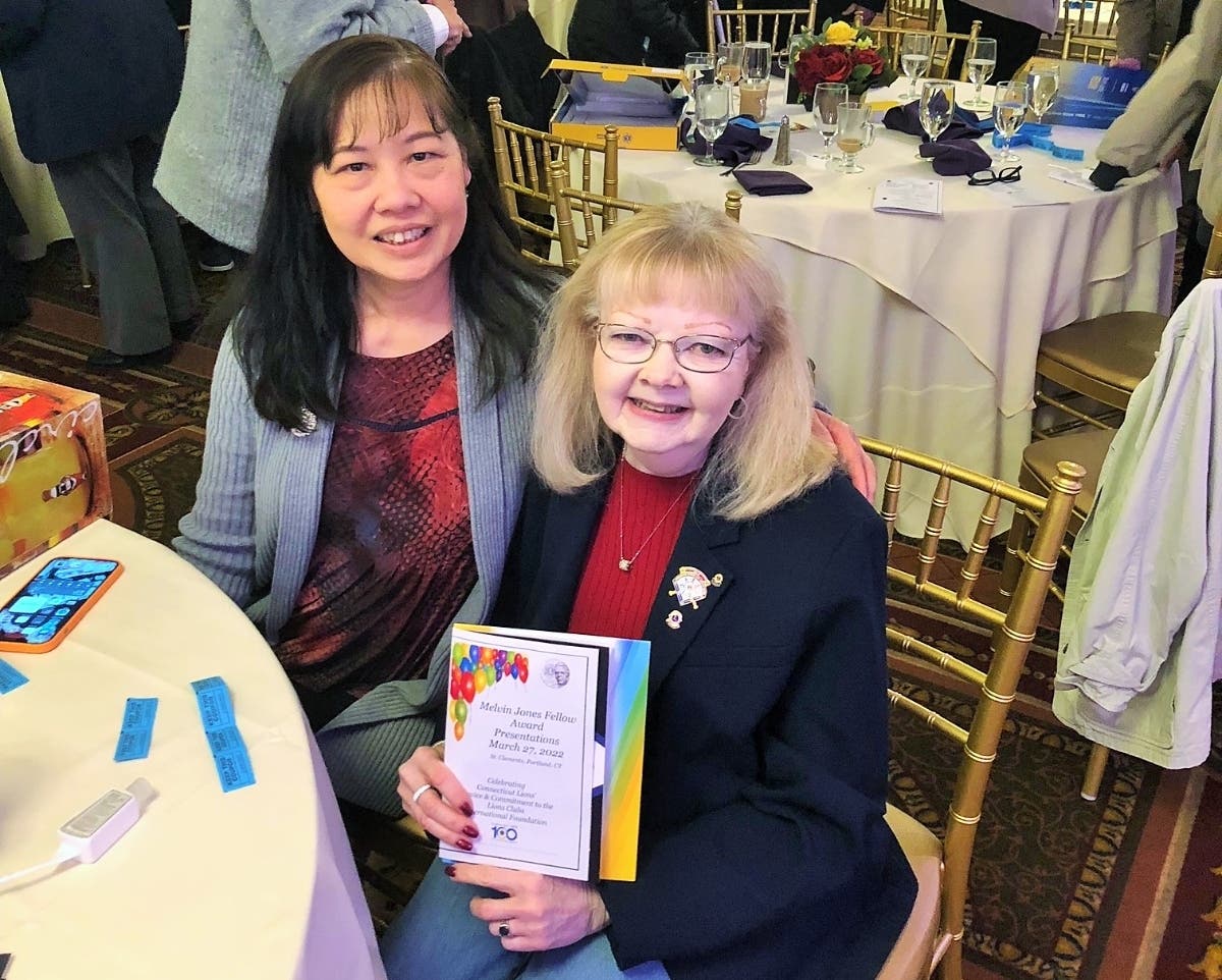 Dianne Bouchard (right) receives the 2023 Melvin Jones Fellow Award 2023, presented for service and commitment to the Lions Clubs International Foundation. At left is Ellington Centennial Lions Club treasurer Nga Nguyen.