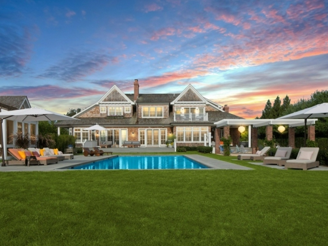 The porches, terraces, pergola, outdoor kitchen, pool and pool house overlooking the neighboring paddocks make the outside of this home an elegant dream.