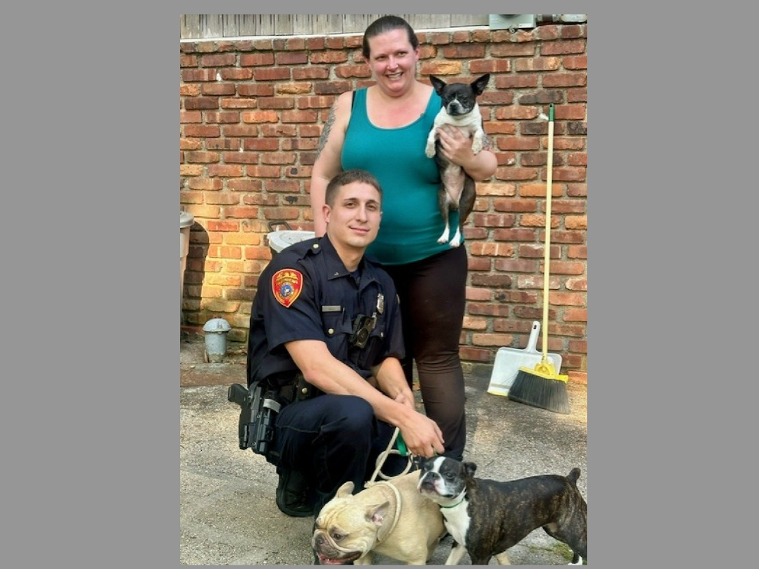 The officer saved all three dogs, police said.