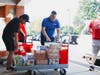 Amazon and other area volunteers brave the hot, humid day to unload car after car of donations from nearly 180 households in the Fort Hunt area, where volunteers received and sorted over 2,700 pounds of food and toiletries at Whitman Middle School. 