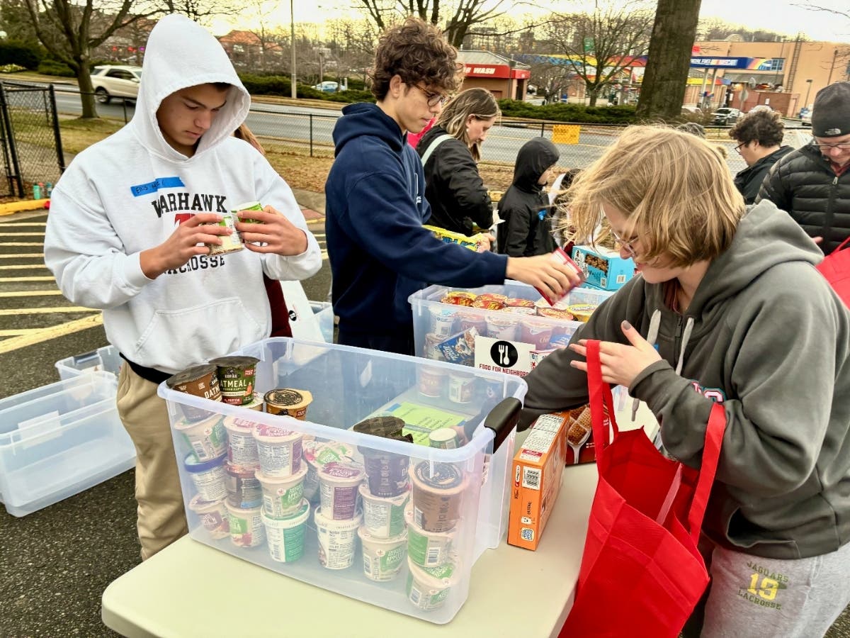 Volunteers gather at Luther Jackson MS to receive and sort thousands of pounds of food and toiletry donations for students in nearby schools.