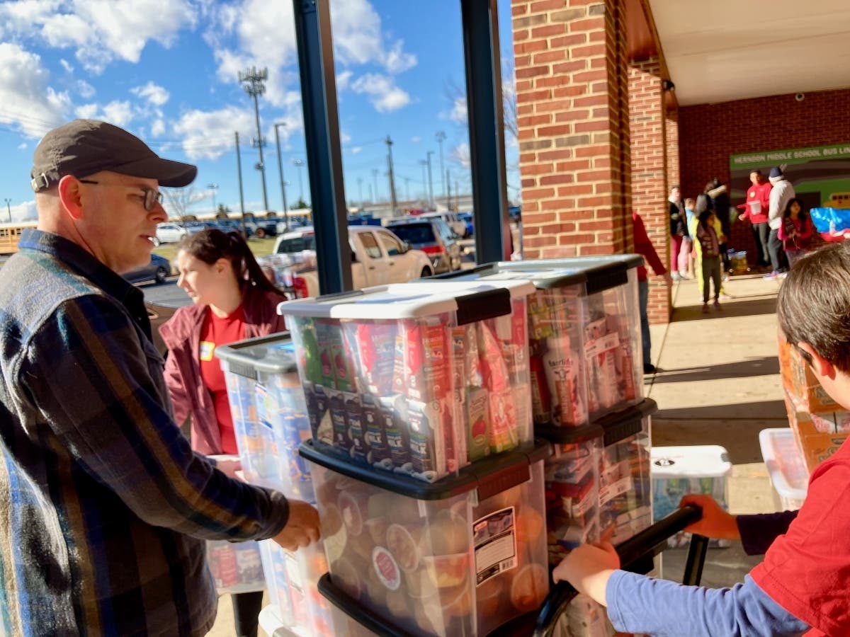 Volunteers load thousands of pounds of collected and sorted food for delivery to nearby schools.