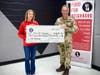 Colonel Joerg Dronia, Commander of the German Armed Forces Command, United States and Canada, presents Karen Joseph, Founder and Executive Director of Food For Neighbors, with a generous donation to tackle teen hunger.