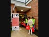 Volunteers of all ages brave the rain to unload and bring inside approximately 5,000 pounds of food and toiletry donations to help local students in need.