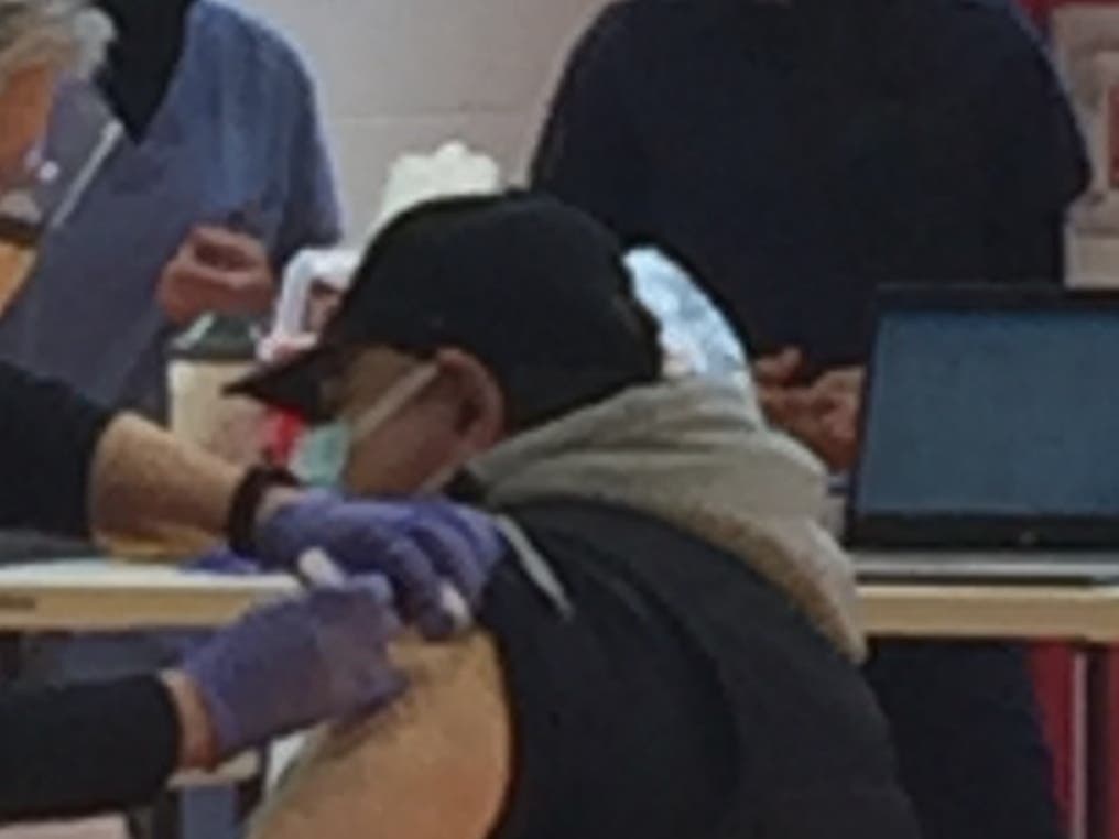 A man gets vaccinated against COVID-19. 