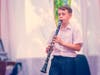 A,Boy,With,A,Clarinet,Plays,Music,Near,The,Window