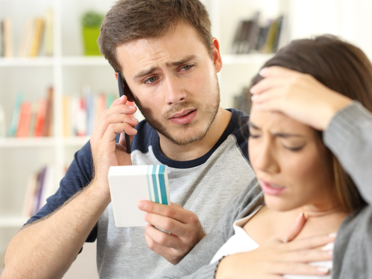 A person calling a medical provider on the phone because a loved one is experiencing side effects after using an over-the-counter medicine.   