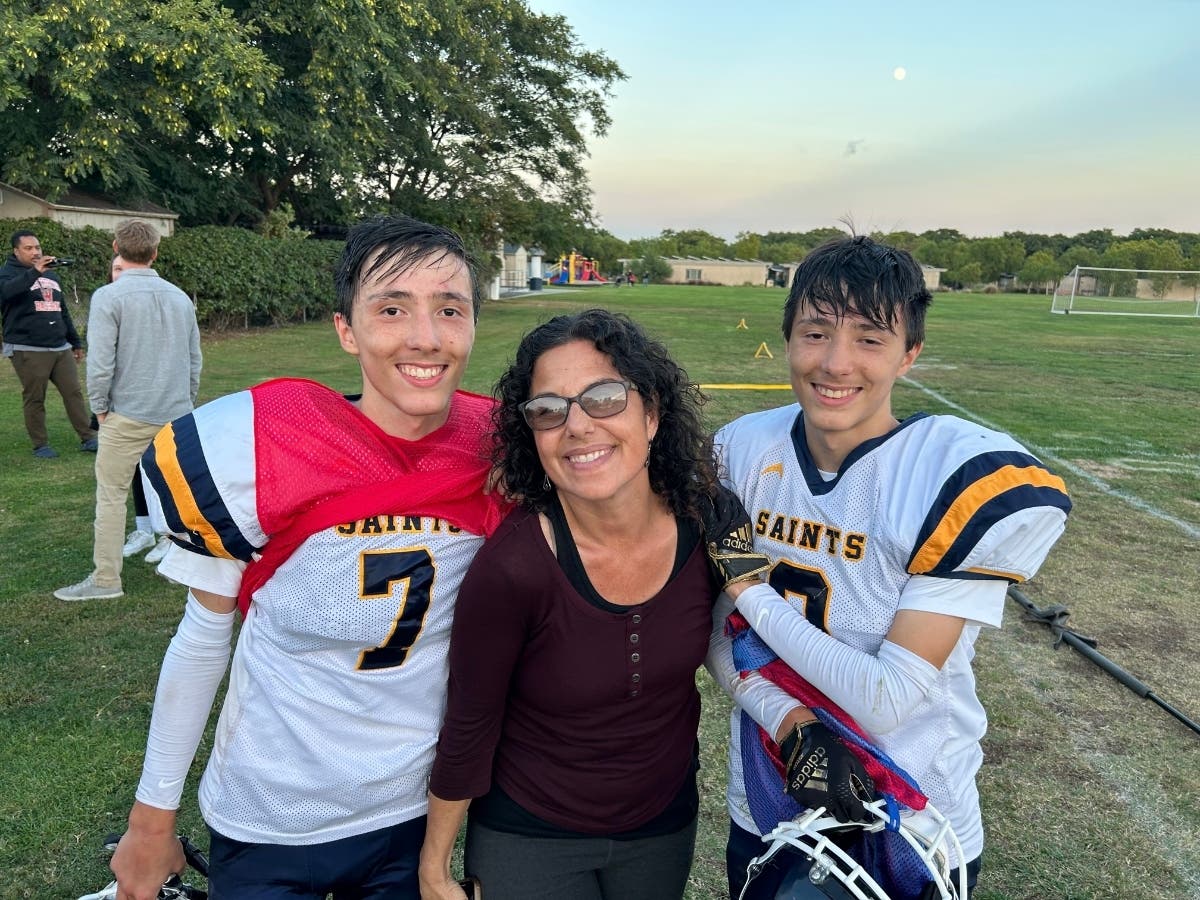 Sean and Owen Toomey pose with their mom after the game, flush with happiness over their successes and growth on the gridiron.