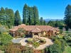 This Mediterranean-style estate is on a Sebastopol ridge with more than 5 acres of lush terrain, featuring soaring redwood trees. The single-level home has over 6,300 square feet of spacious living with 5 bedrooms, 6 baths, and a 1-bedroom guest house.