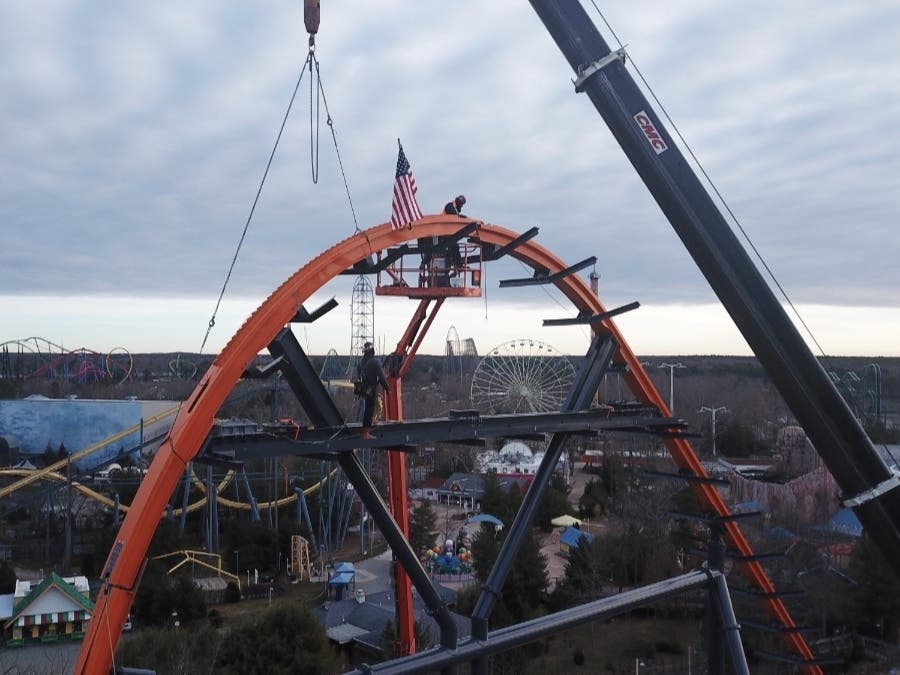 Workers connect the final piece of track for the Jersey Devil Coaster at Six Flags Great Adventure in Jackson on Monday. 