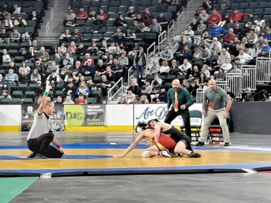 Anthony Santaniello scores a takedown in the first period of his 132-pound state title bout against Jack Bastarrika of Mount Olive. He won by a 10-0 major decision for his second state championship in four trips to the NJSIAA state finals. 