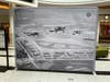 Planes fly over Roosevelt Field airfield in 1931. The hangers below bordered what is now Clinton Avenue, running left to right, and Old Country Road on the left. The image is part of Cradle of Aviation Museum's current exhibit at Roosevelt Field mall. 