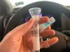 The coronavirus spit test in action at a test site in North Bergen: You stay in your car and spit into a test tube.