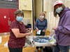 Tina Goldman (left) and her grandson Ben Williams (right) help create “Blessing Bags” for the homeless, along with 40-year YMCA member Cynthia Nadig (center). 